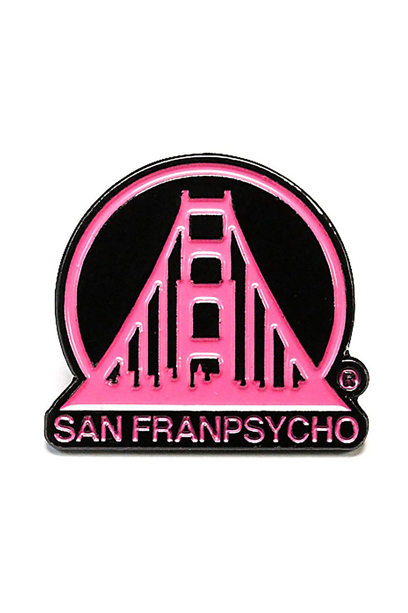 The Black & Pink SFP Logo Pin is a custom enamel pin featuring a stylized Golden Gate Bridge with the text "San Franpsycho." It is designed as a 1-inch enamel pin with a strong hold clutch for secure attachment.