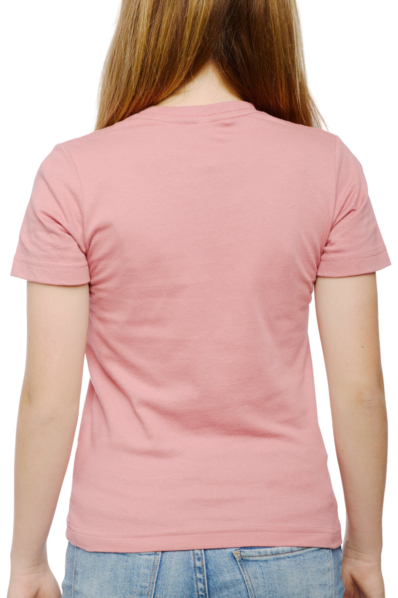 A person in a pastel pink Youth Sutro Tower Tee and blue jeans is seen from the back, strolling casually.