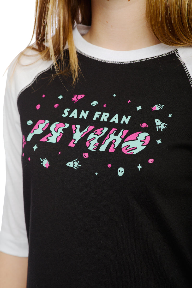 Close-up of the Youth Planet Rock Baseball Tee, featuring black and white sleeves with vibrant text and graphics that read San Fran Psycho, exuding 90s vibes.
