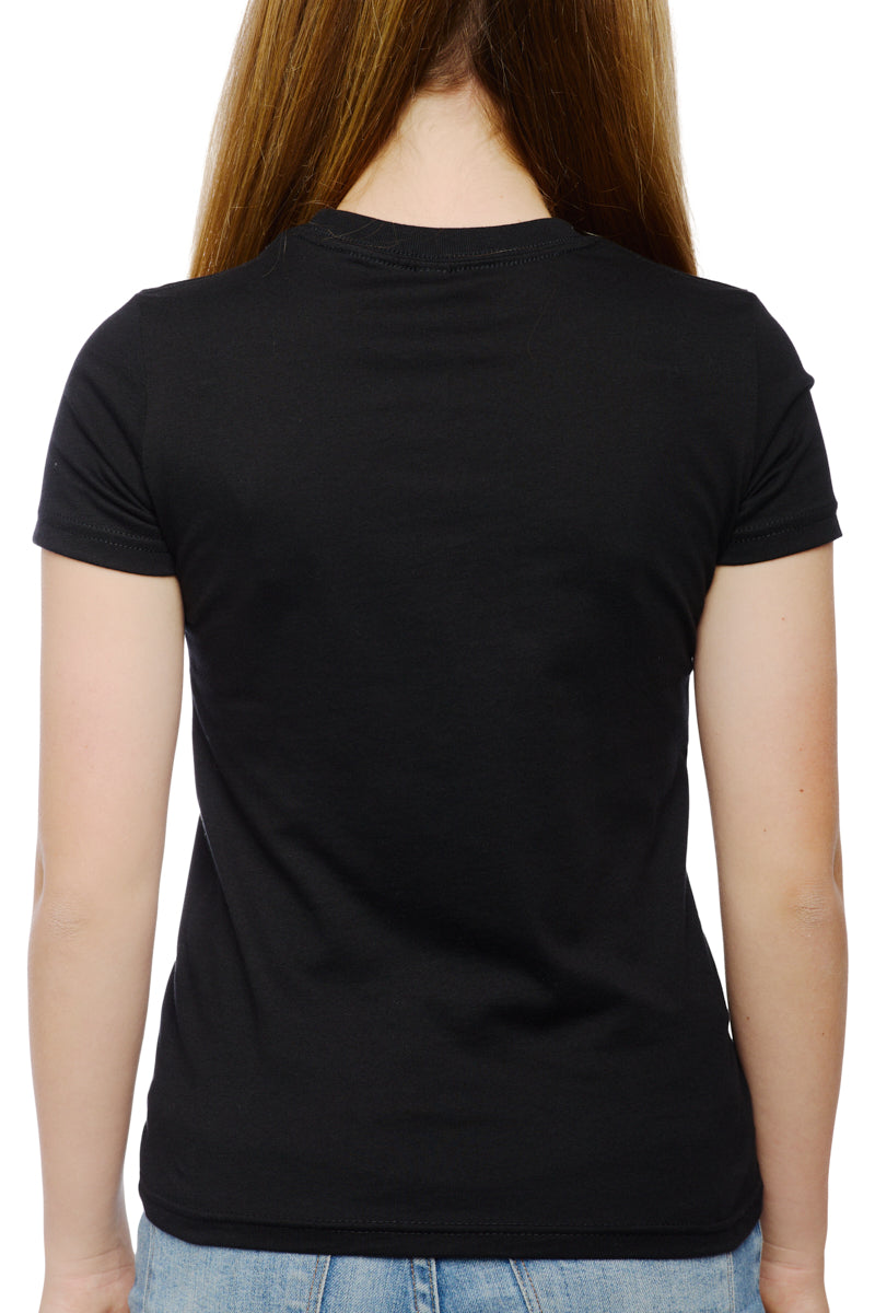 A woman with long hair stands with her back to us, wearing jeans and the Youth Black Street Skull Tee. The casual silhouette captures the laid-back style of its street skull design, fitting effortlessly into an urban scene.