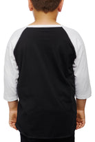 A child wearing a Youth Planet Rock Baseball Tee in classic black and white, exuding 90s vibes, stands with their back to the camera.