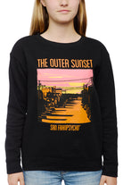 A person wearing the Youth Outer Sunset Crewneck showcases a hand-printed sunset illustration, accompanied by the text "The Outer Sunset - San Franpsycho," embodying the relaxed atmosphere of San Francisco.