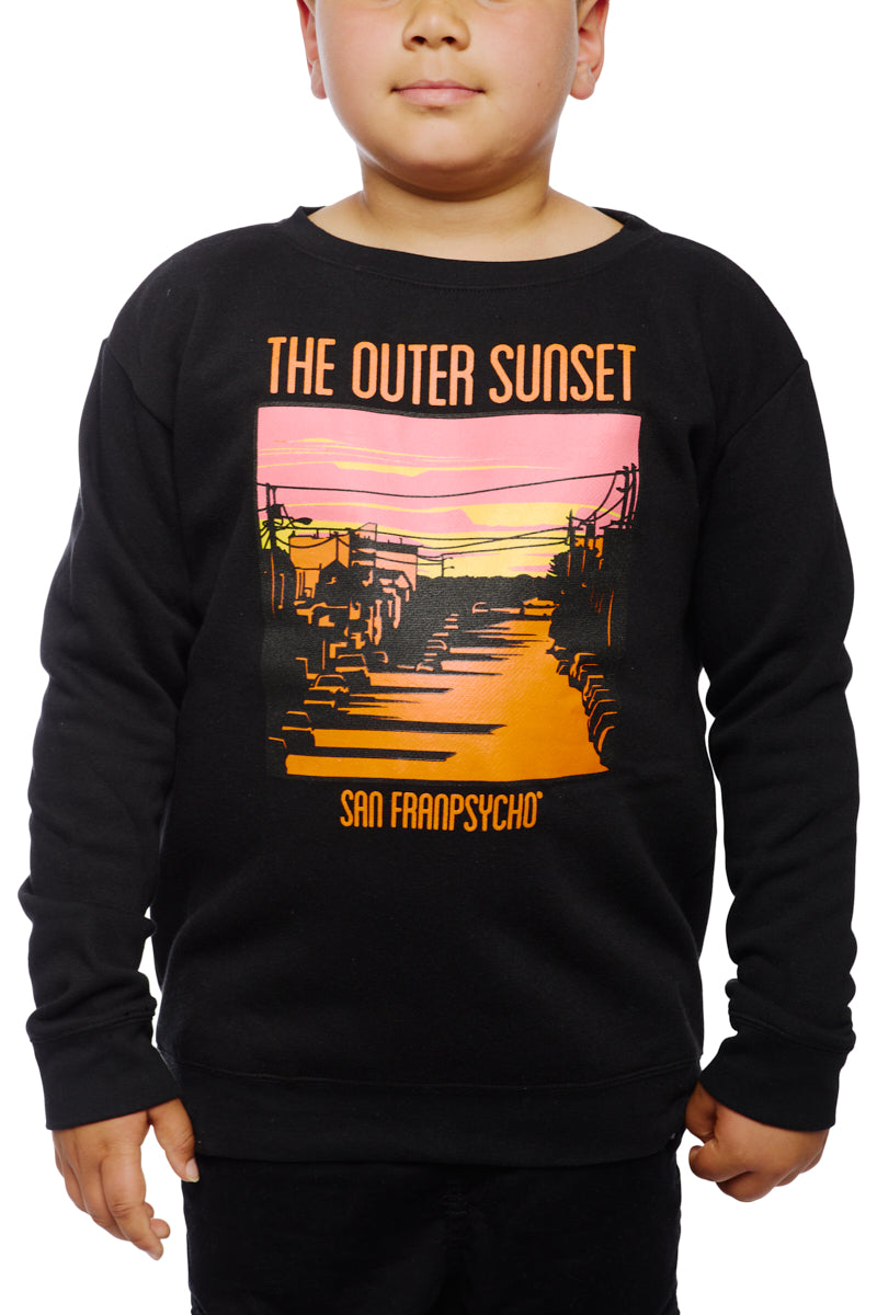 A child wears the Youth Outer Sunset Crewneck, a black sweatshirt adorned with a hand-printed, colorful sunset graphic and the text THE OUTER SUNSET SAN FRANPSYCHO, embodying the lively spirit of San Francisco.