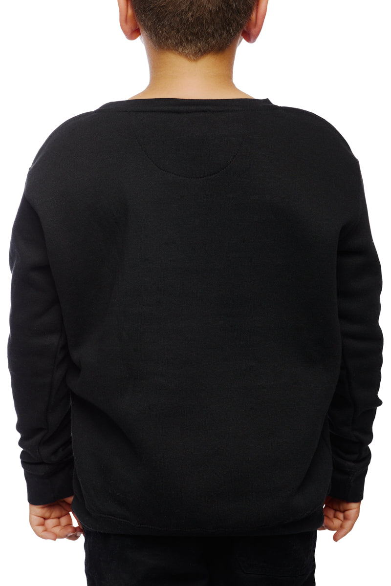 A child, wearing the Youth Outer Sunset Crewneck in hand-printed black, stands facing away from the camera against a stark white background.