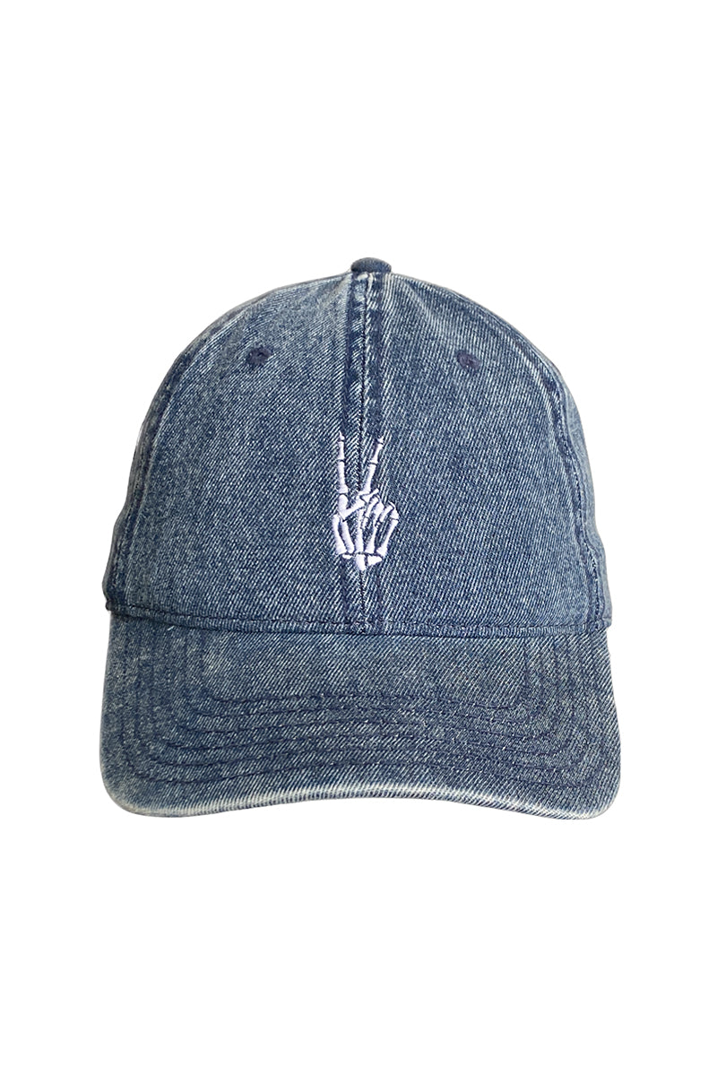 The Blue Denim Peace Bones Dad Hat features an unstructured fit with an embroidered skeleton hand peace sign on the front, blending comfort and bold style in a distinctive design.