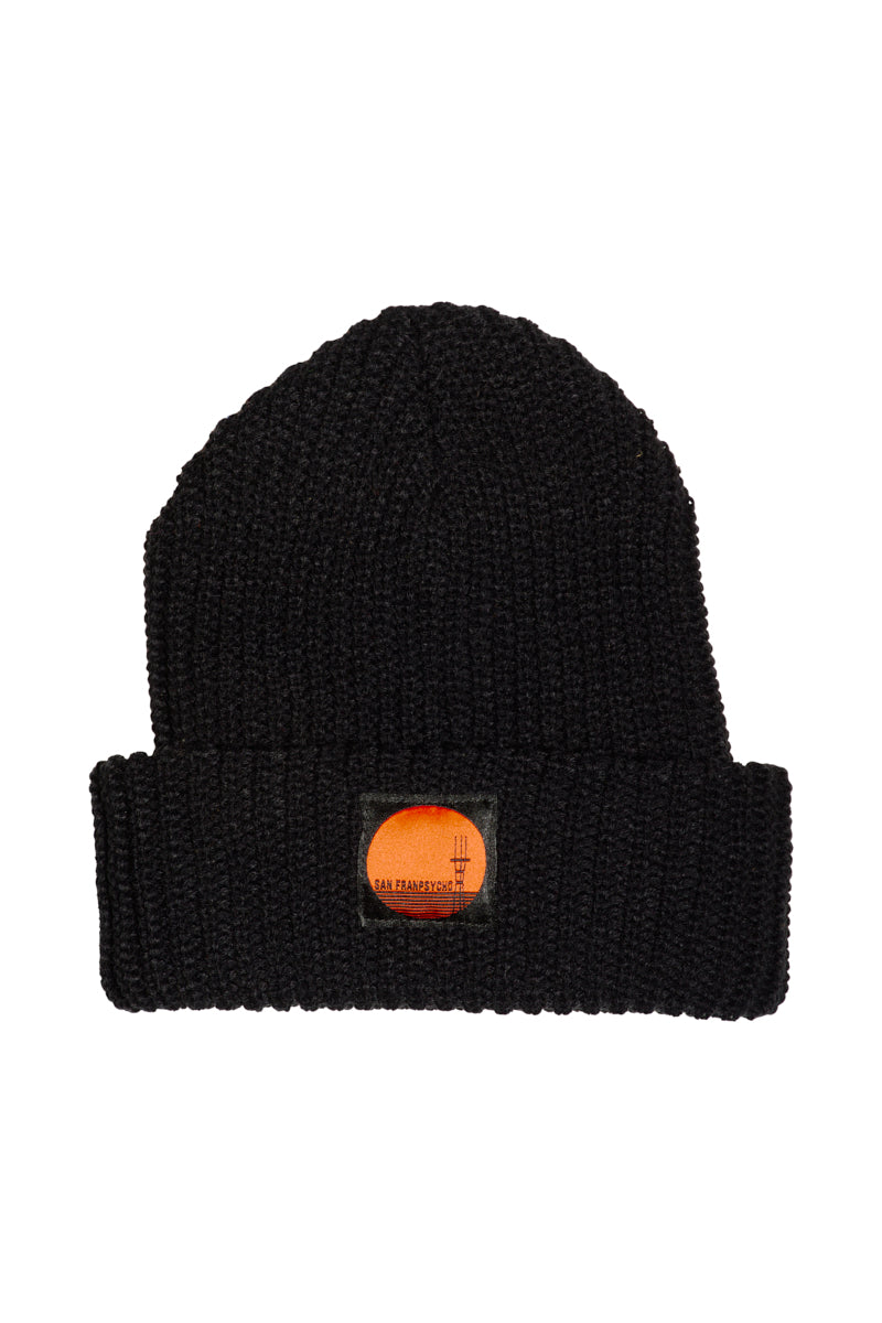 The Black Lumberjack Beanie w/ Sutro Logo features a classic black knit design, a folded brim, and an orange patch with the iconic Sutro Tower logo on the front.