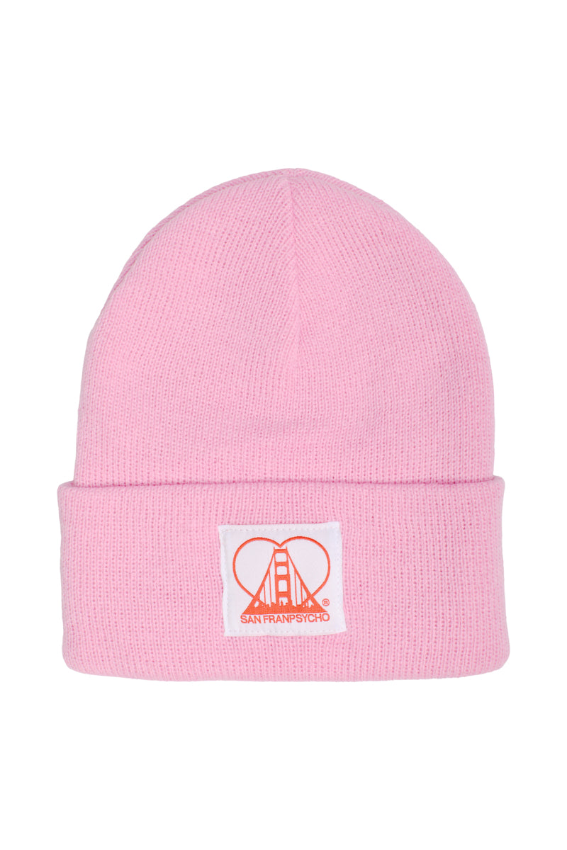 The Pink Kids Beanie with Heart Patch is a stylish knit beanie for kids featuring a white patch with an orange design and San Franpsycho text, perfect for staying warm on chilly days.