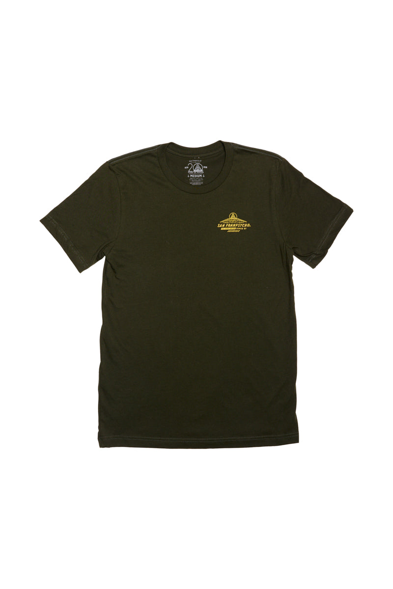 Introducing the Breakers Tee for Spring/Summer 2024: a sleek dark green t-shirt made from high-quality Airlume cotton, highlighted by a subtle yellow logo on the chest set against its sophisticated plain backdrop. Ideal for achieving both comfort and effortless style this season.