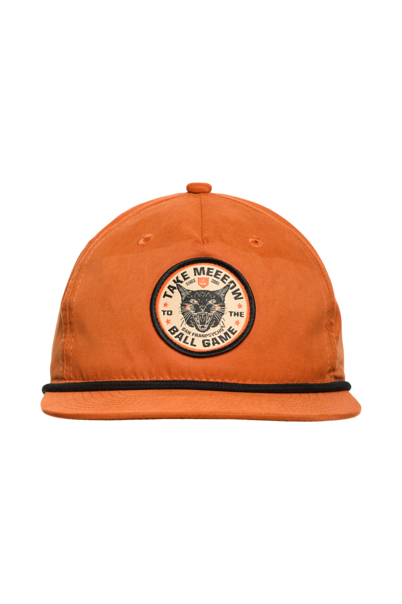 Orange Take Meeeow Patched Hat with a round patch reading Take Meeeeow to the Ball Game and a decorative black line above the brim, perfect for baseball season.