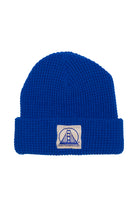 The Royal Blue Waffle Beanie w/ Natural/Blue Logo combines style with soft comfort, featuring a patch with a stylized bridge design.