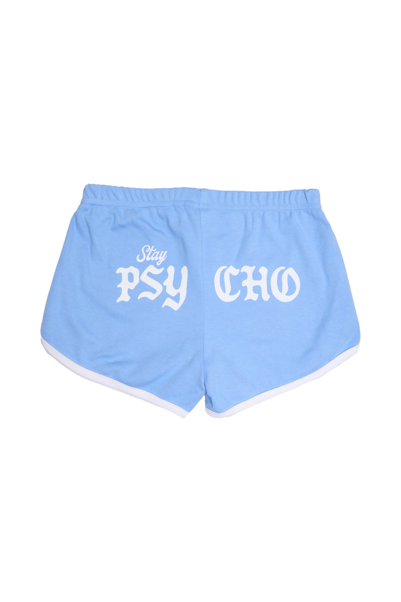 The Stay Psycho Booty Shorts - Blue are cozy light blue shorts with white trim, made from 100% cotton, and feature Stay PSY CHO in bold white gothic letters on the back.