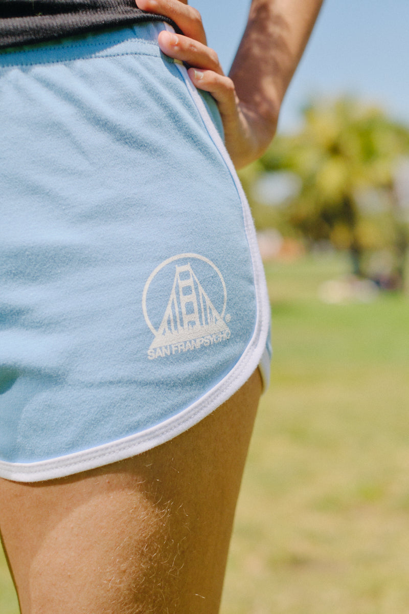 Wearing comfy, lightweight Stay Psycho Booty Shorts - Blue, detailed with a white Golden Gate Bridge outline and San Fransycho logo.