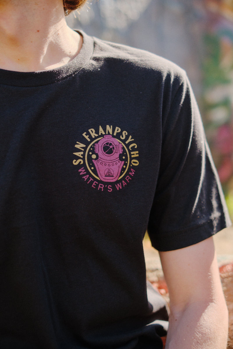 Someone wears the Psycho Siren Tee, hand-printed on soft Airlume cotton with a colorful San Franpsycho Waters Warm graphic on the chest.