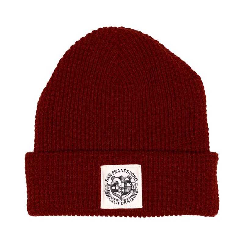 The Bear Essentials Rust Beanie features a white San Francisco California patch on its folded brim—delivering classic West Coast style.