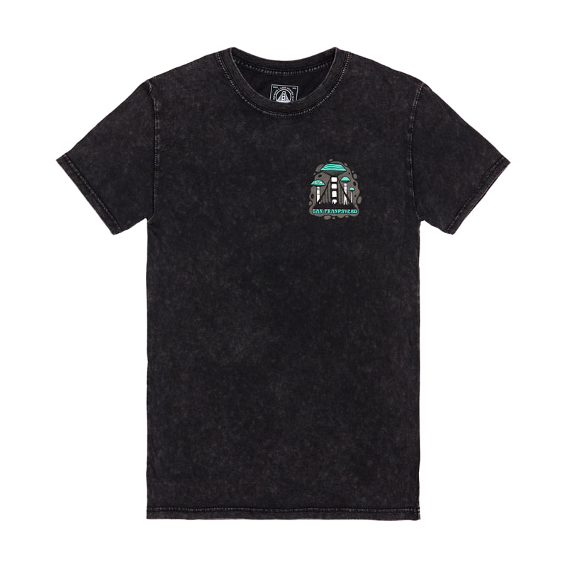 The Mind Bloom Tee is a black mineral wash shirt with a small, colorful skull and mushroom graphic on the left chest, inspired by Erik Abel’s artwork.