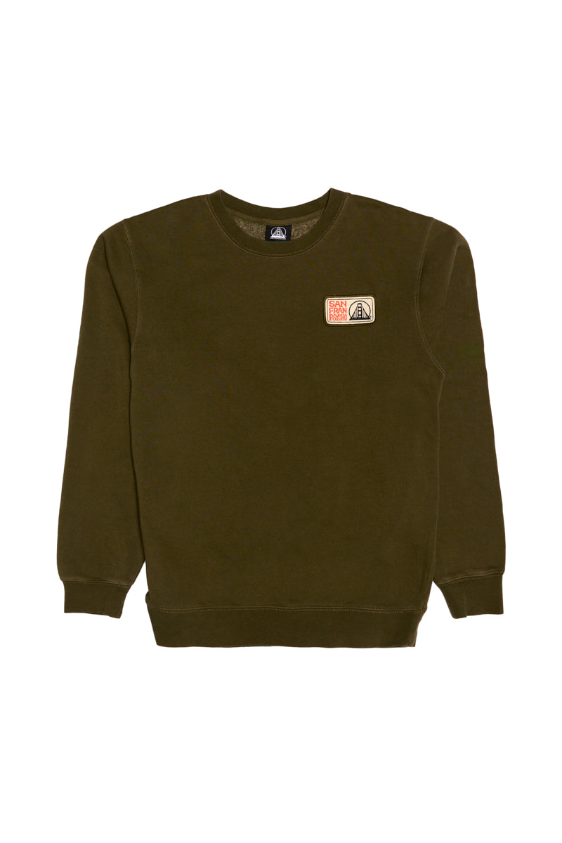 The Elemental Crewneck is an olive green San Francisco sweatshirt featuring two small embroidered patches on the left chest, made from 100% cotton and displayed on a white background.