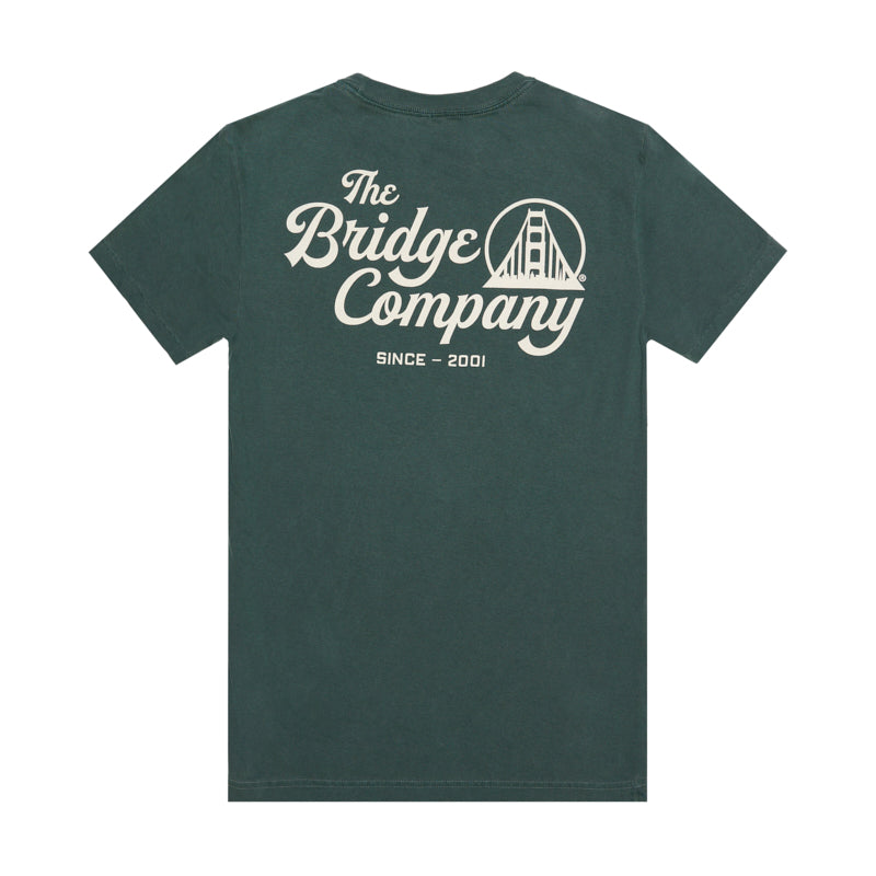 The Bridge Co Tee is a forest green heavyweight cotton shirt with "The Bridge Company," a bridge graphic, and "Since 2001" hand printed on the back.