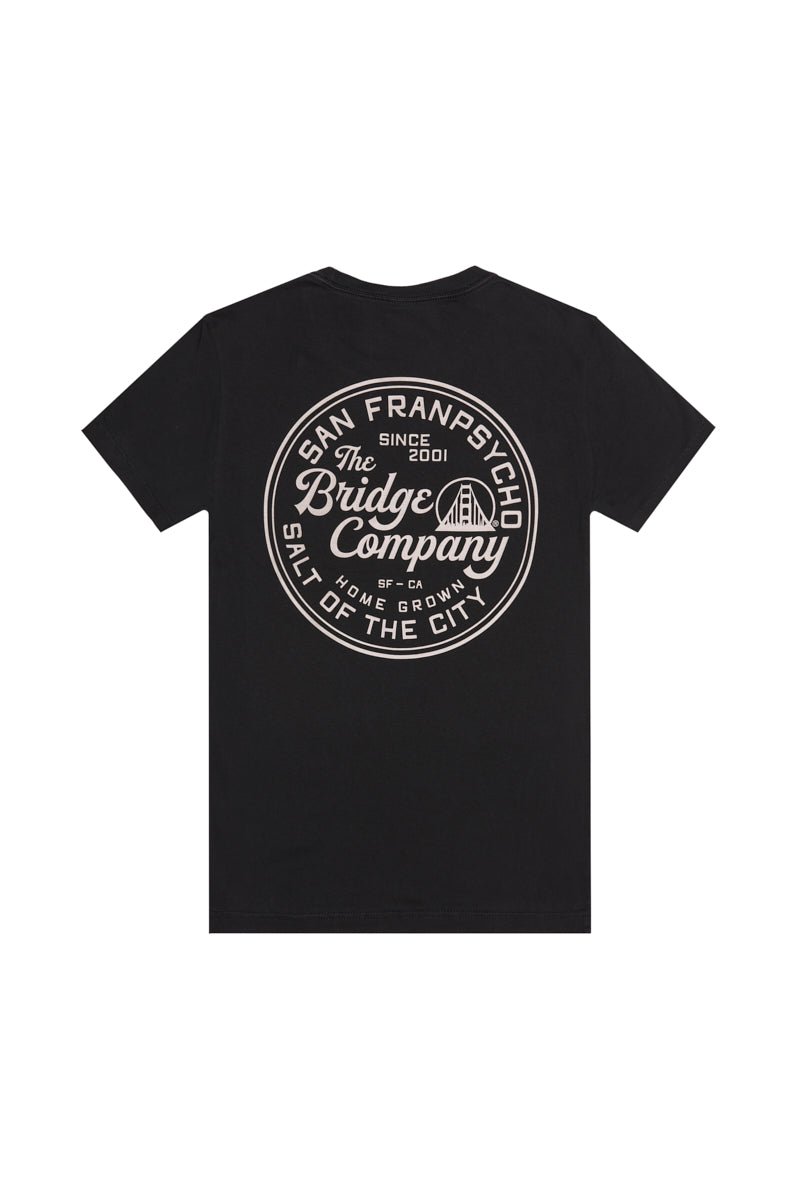 The Salt of the City Tee is a black heavyweight cotton shirt with a large round white "San Franpsycho The Bridge Company" logo on the back, hand printed in San Francisco—ideal for fans of quality workwear and local craftsmanship.