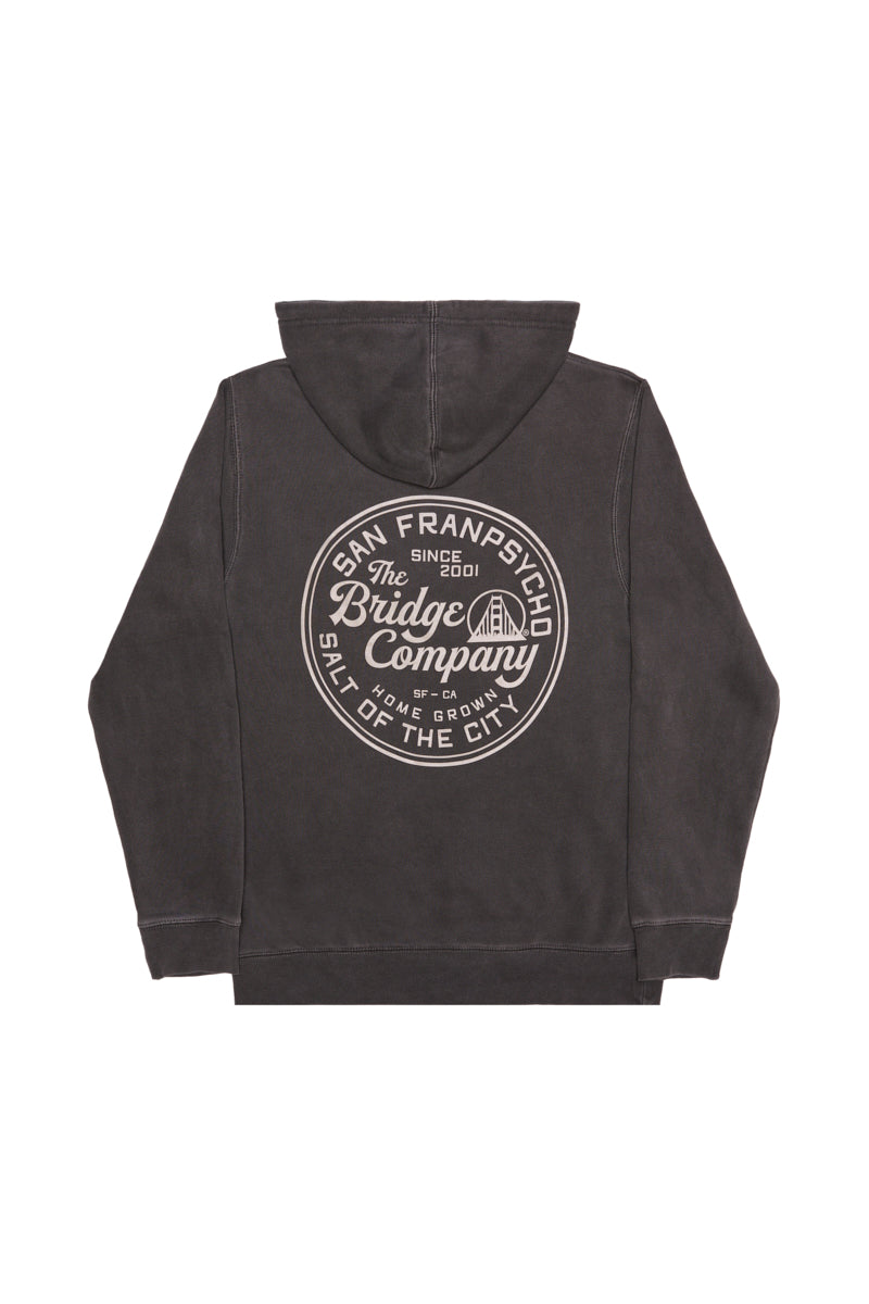 Salt of the City Pullover Hoodie: A black unisex hoodie featuring a large circular The Bridge Company graphic on the back, inspired by San Francisco—perfect for laid-back city style.