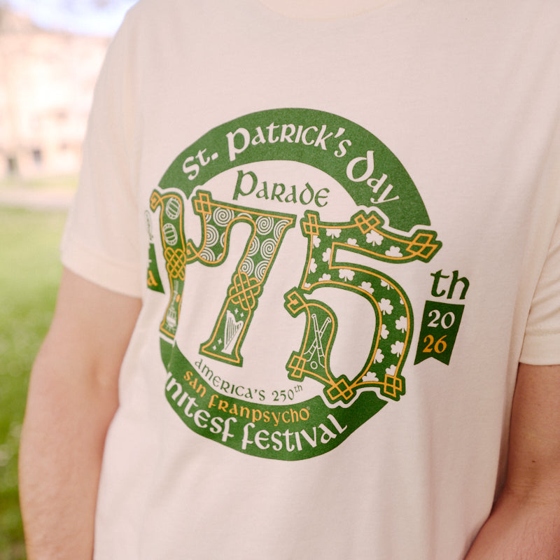 A man stands outdoors wearing the 175th St Patrick's Day Parade Tee, a limited edition shirt made for the San Francisco Irish Festival.