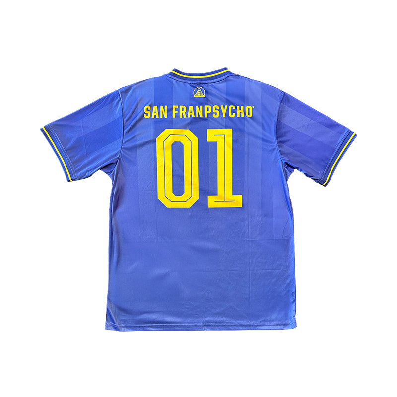 The WC x SFP Jersey - Blue features yellow trim, SAN FRANPSYCHO, and the number 01 on the back—a fan favorite inspired by classic World Cup jerseys.