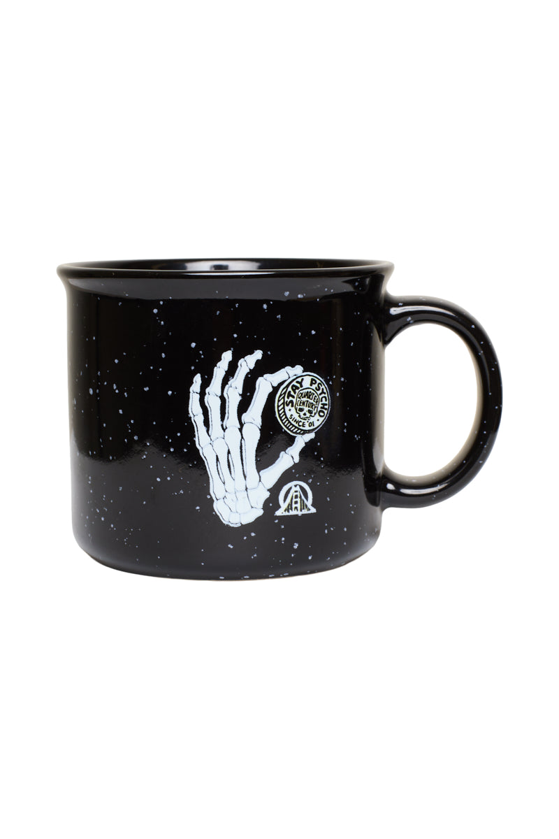 Quarter Cent Mug featuring a black speckled ceramic design with a skeleton hand holding a coin and Stay Psycho text.