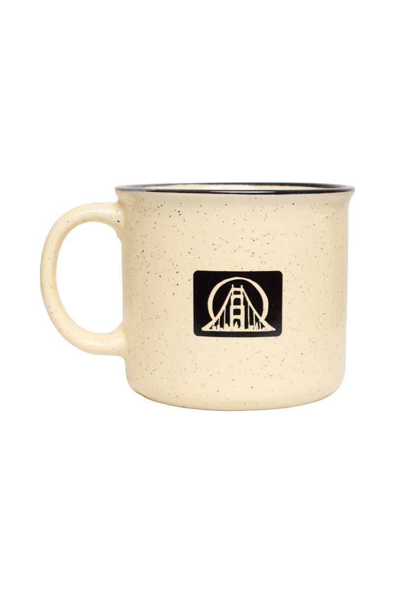 Cream-colored Icons Mug by San Franpsycho, a speckled ceramic mug featuring a black square bridge silhouette logo.