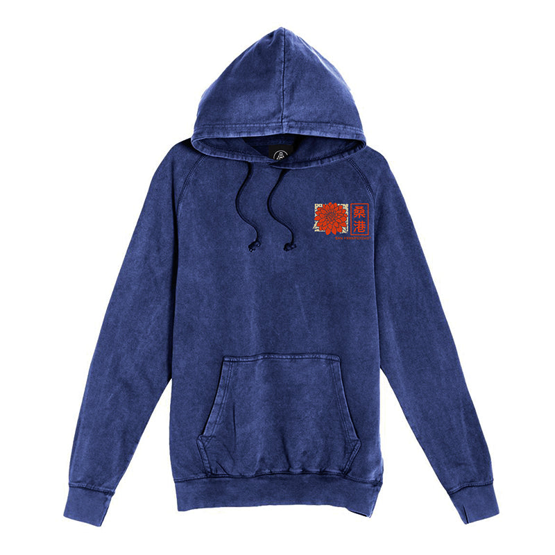 Sunset Dahlia Pullover Hoodie featuring a blue mineral wash finish, a hood and kangaroo pocket, and a subtle orange graphic on the left chest inspired by vintage textures and Japanese art tee aesthetics.
