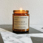 Amber candle from North Bay Candleworks labeled San Francisco, part of the Marin Landmark Line, resting elegantly on a marble surface.