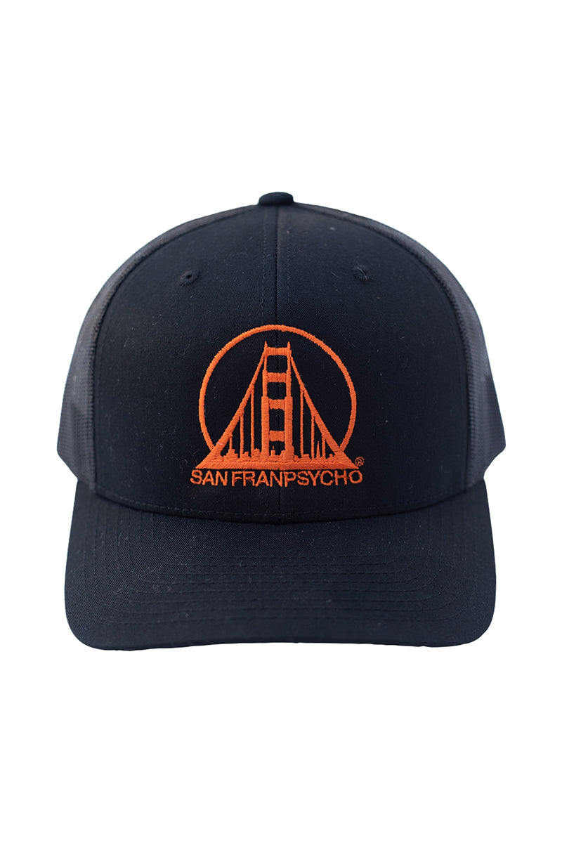 The Embroidered Logo Trucker Hat in black and orange boasts an adjustable fit and features a stylized San Franpsycho logo with a Golden Gate Bridge design, blending comfort and style for casual outings.