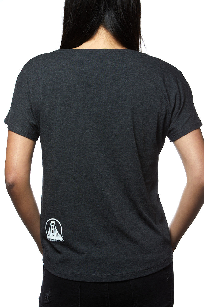 A person is wearing the Charcoal & Orange Dolman T-shirt featuring a small white logo on the lower back, hand-printed in San Francisco.