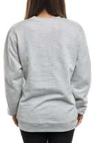 A person wearing an Inner Sunset Crewneck and black pants stands facing away from the camera against a white background, reminiscent of the serene pathways of Golden Gate Park in San Francisco.