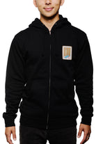 A person wearing the Black Muir Woods Patched Zip-Up Hoodie made from 100% cotton, featuring a small colorful patch on the chest, ideal for those who love to wander.