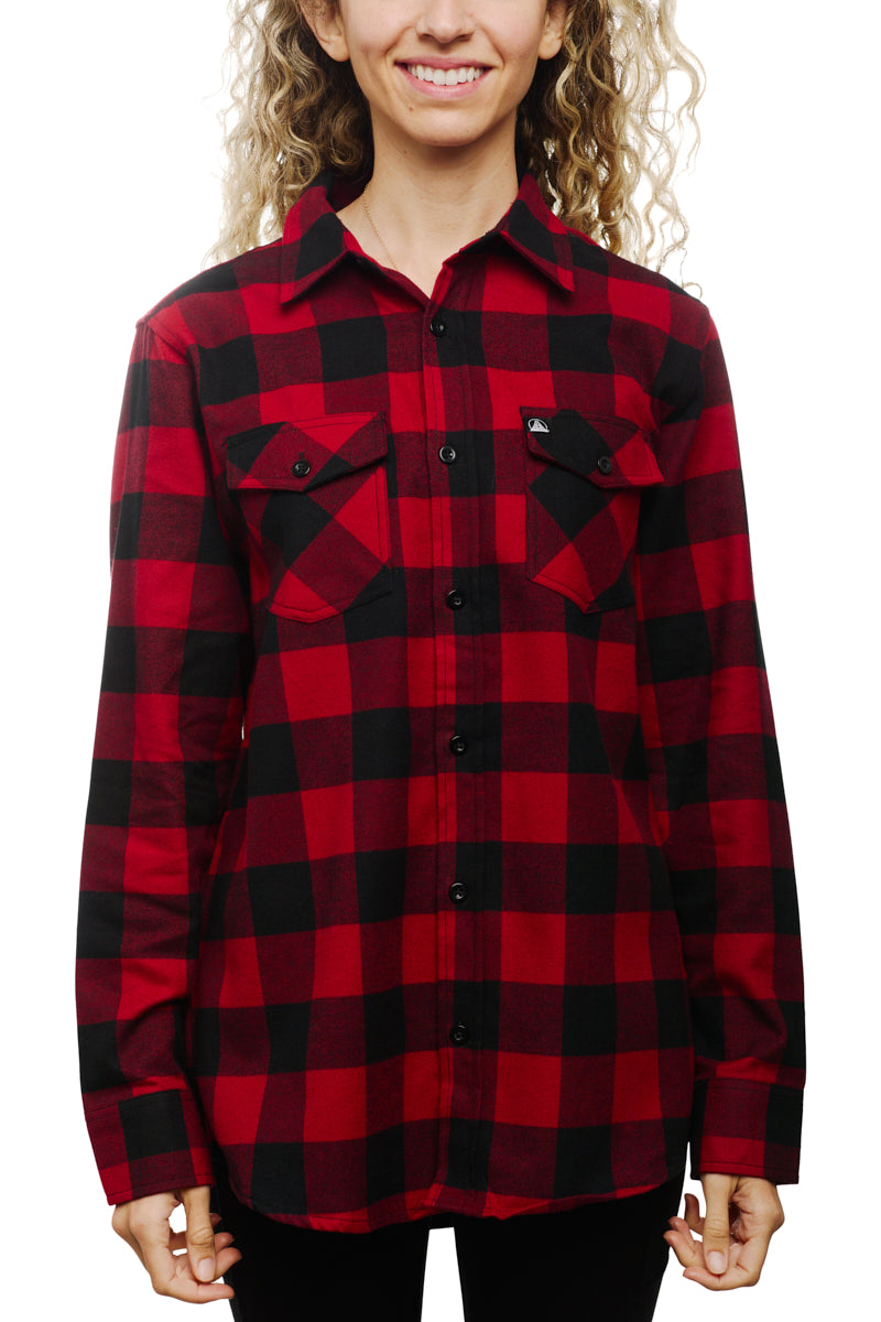 The person is wearing the Red & Black Checkered SFP Flannel, featuring a super soft texture and buttoned pockets, while standing against a white background.