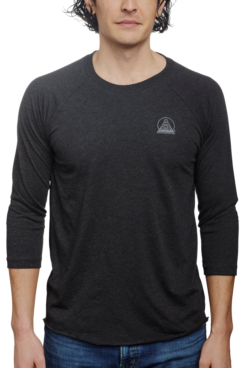 A person wearing the Charcoal Raglan w/ Mini Logo from the basics line, ideal for everyday wear.