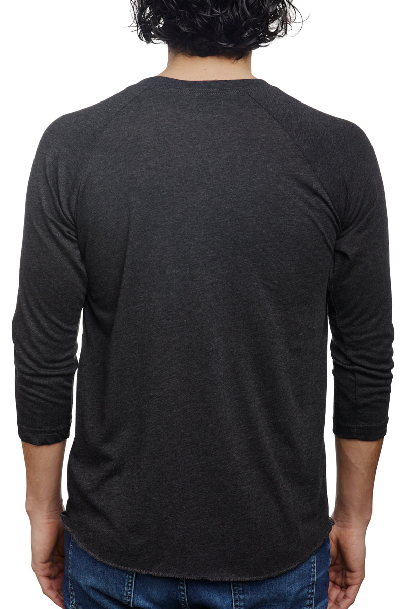 Viewed from the back, an individual wears a casual outfit consisting of a Charcoal Raglan with a Mini Logo and classic blue jeans.