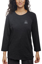 Woman wearing the Charcoal Raglan with Mini Logo, a black long-sleeve shirt from our basics line.