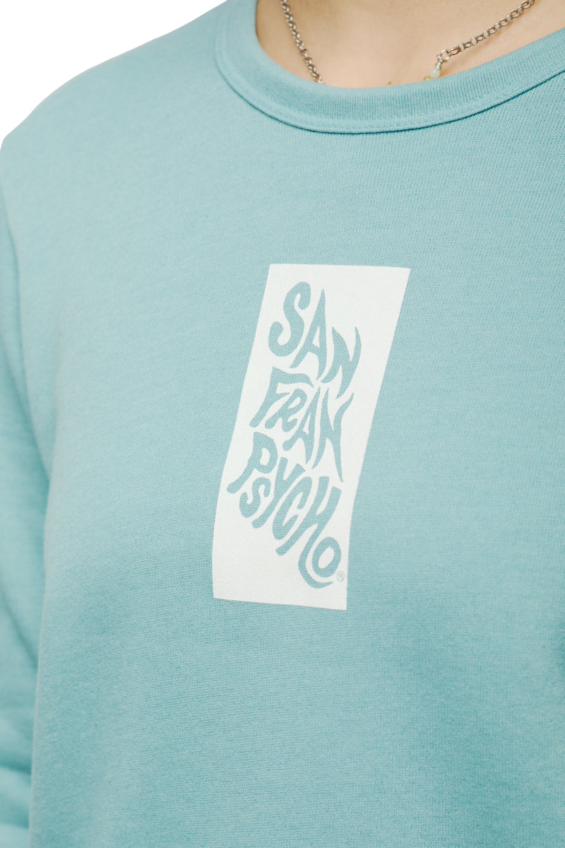 Clad in the Trippy Psycho Women's Crewneck from the Spring 2023 Collection, an individual displays a San Fran Psycho graphic design prominently on the front, with the garment made from a super-soft cotton/polyester blend.