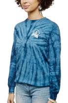 A person wearing a Tie-Dye Acid Logo Long Sleeve in navy, paired with light blue jeans, stands against a pristine white background.