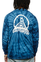 Someone is wearing the Tie-Dye Acid Logo Long Sleeve in navy, featuring the San Franpsycho design and a stylized bridge graphic on the back.