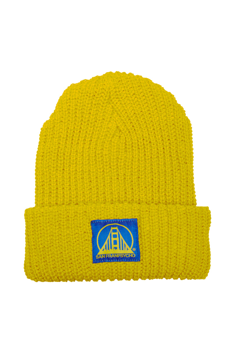 This mustard lumberjack beanie, featuring a blue and yellow San Francisco patch with a bridge design, is perfect for your urban-adventurer style.