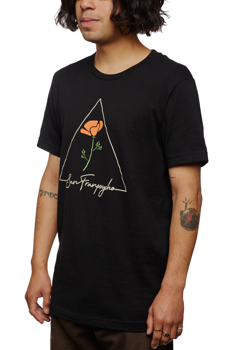 A person wearing the California Poppy Tee, a 100% cotton black T-shirt featuring a Black Poppy graphic and San Francisco text, showcasing this unisex tee.