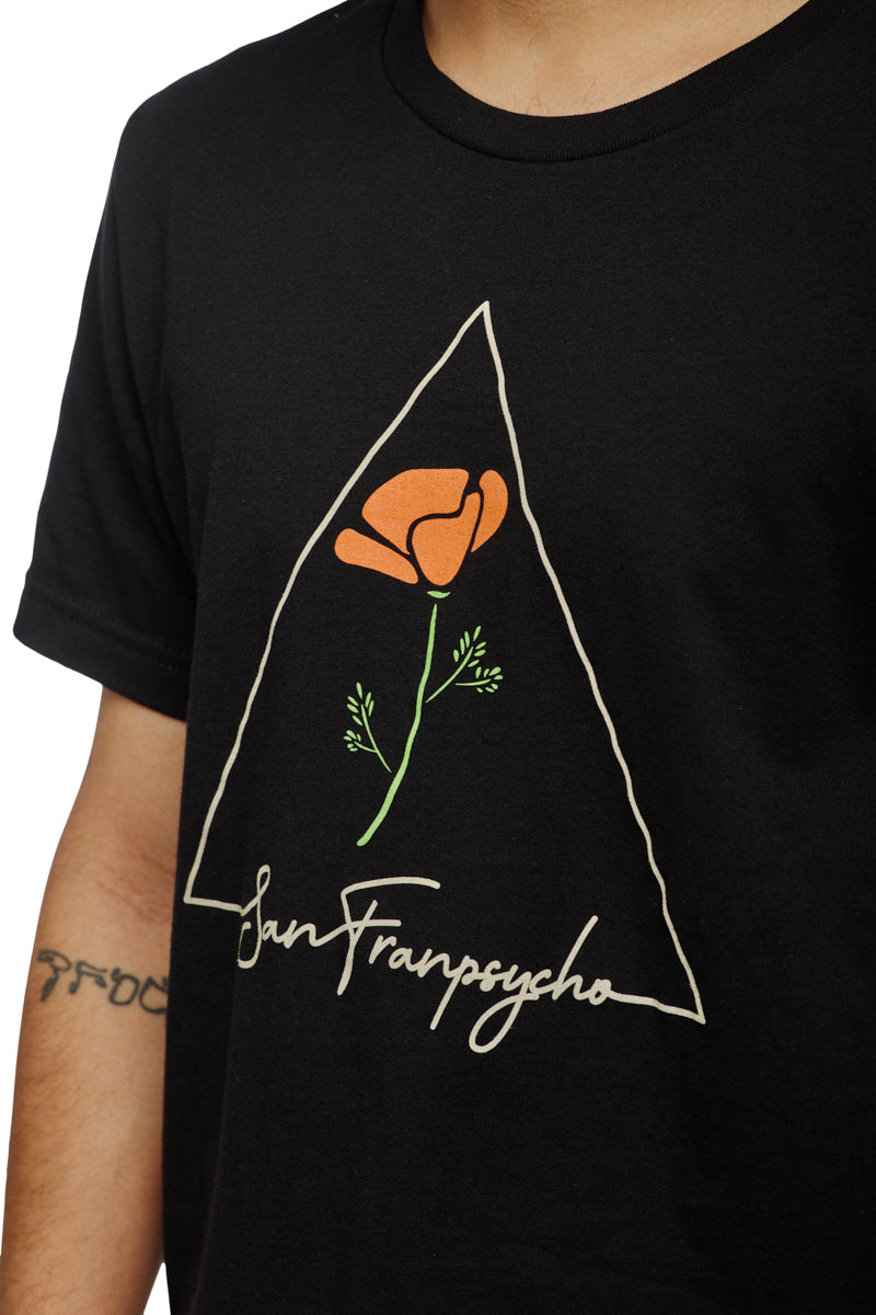 A person wearing the California Poppy Tee, featuring an orange poppy design inside a triangle with San Franpsycho text, crafted from 100% cotton.
