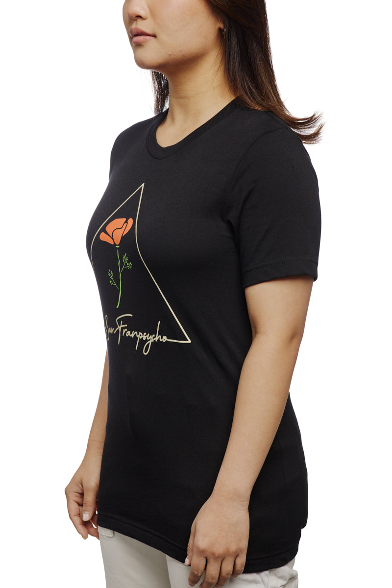 A woman in a black t-shirt featuring a California Poppy rose design and text stands against a white background. This stylish, 100% cotton tee offers effortless elegance and ensures comfort, making it your new favorite go-to unisex piece.