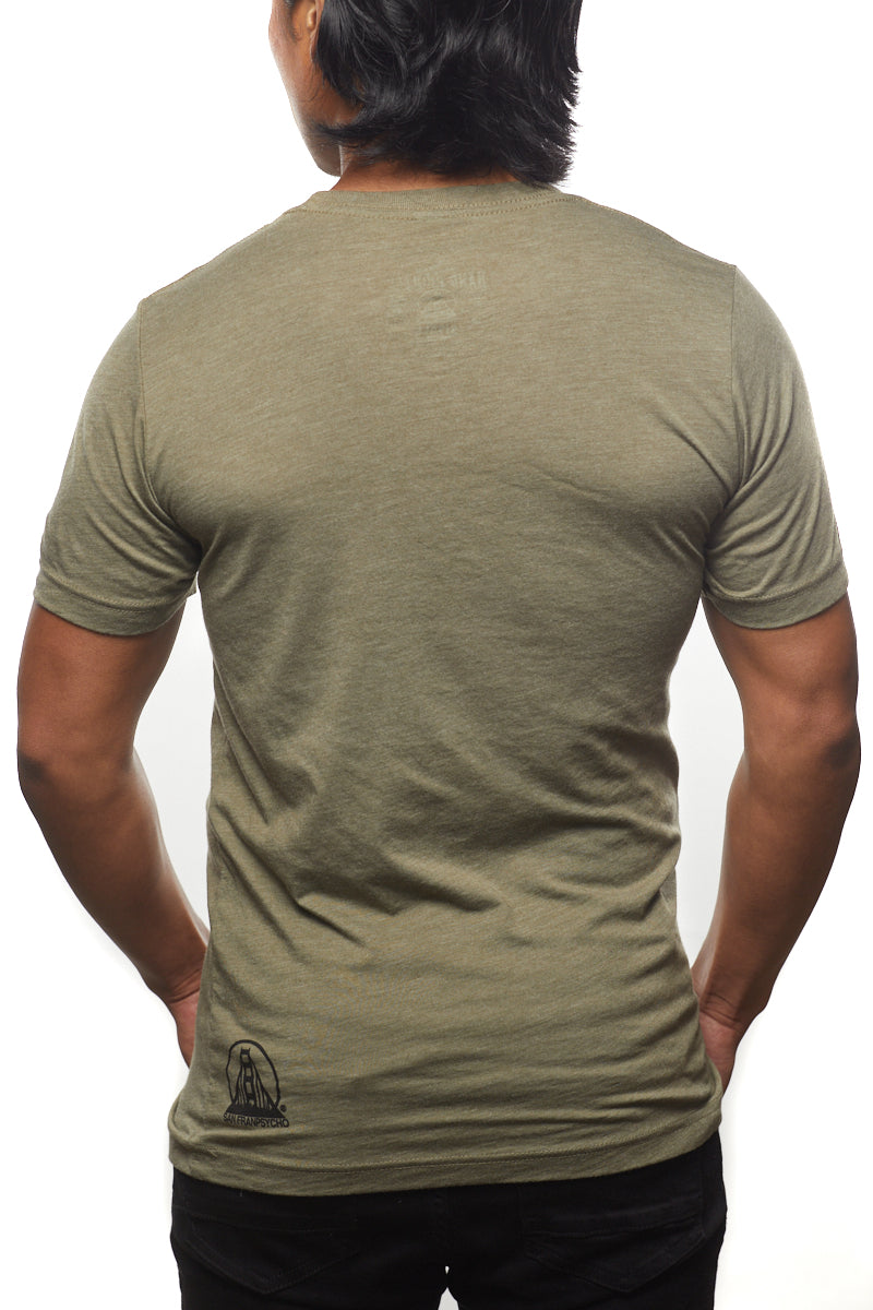Wearing a Cali Bear Tee and black pants, a person stands with their back to the camera against a white backdrop.
