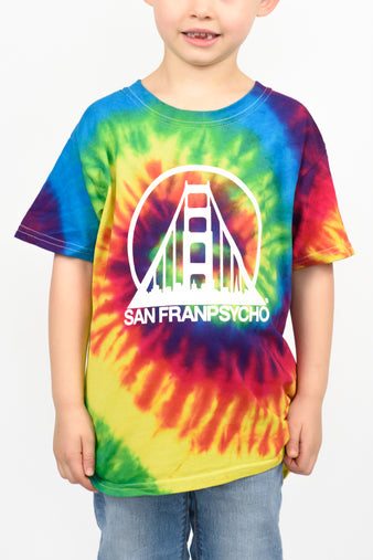 Wearing a Youth Tie-Dye Tee adorned with San Franpsycho's logo and a bridge design, the child smiles against a plain background.