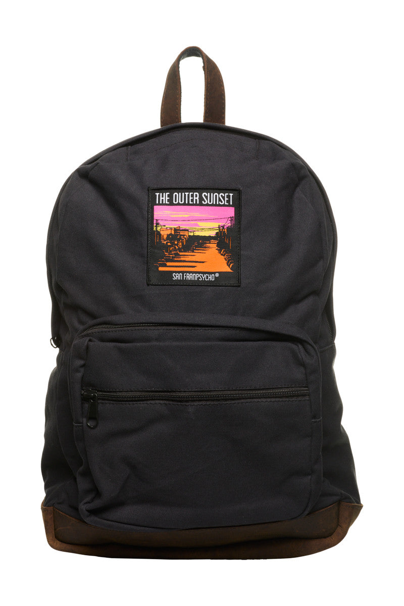 The Black Backpack w/ Outer Sunset Patch features leather trims and a vibrant patch with a sunset scene and "The Outer Sunset, San Franpsycho" text.