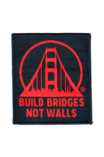 The "Build Bridges Not Walls Patch" showcases an eye-catching red bridge design with the phrase on a chic black background. This iron-on patch makes a powerful statement, effortlessly blending style and significance.