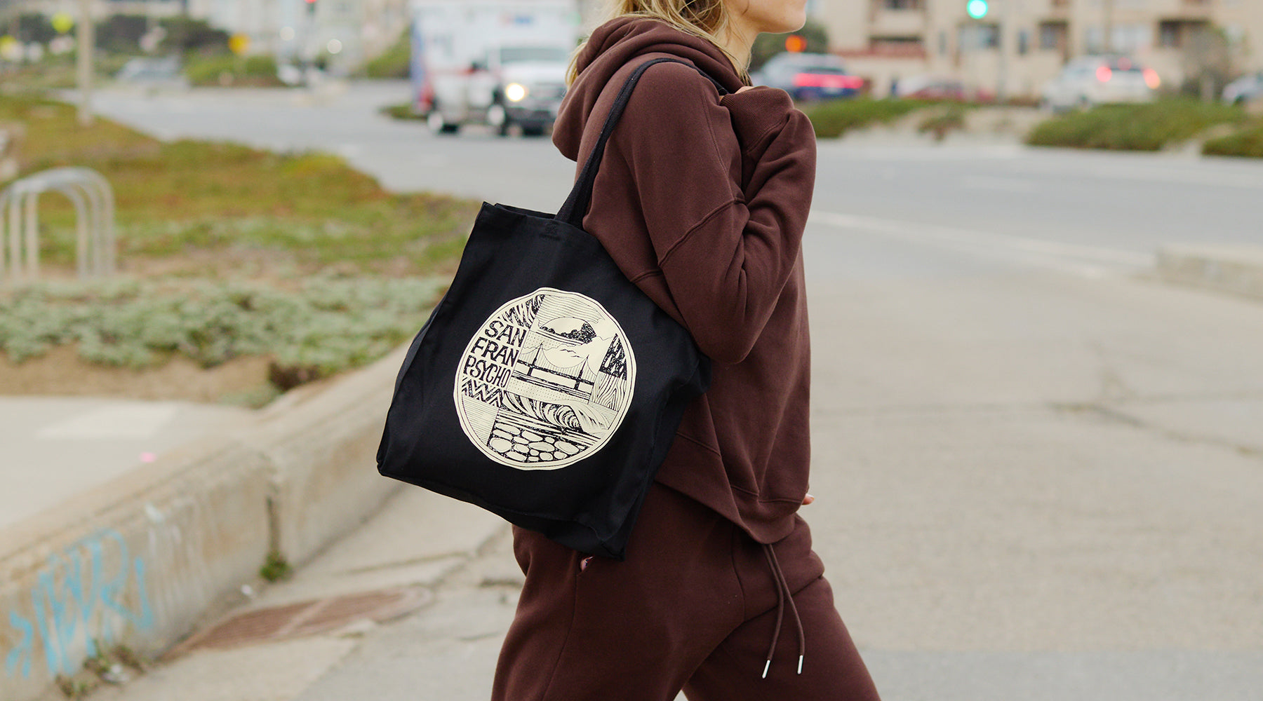 woman holding cat house tote bag