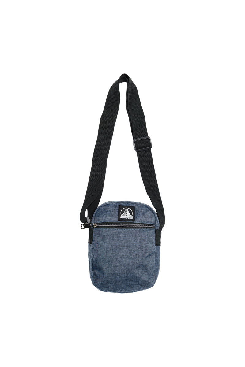 The Small Sling Bag is a blue crossbody with a black adjustable strap and zippered pockets, ideal for fans of compact sling bags; shown isolated on a white background.